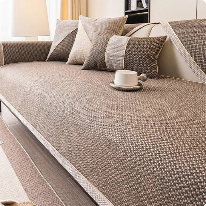 Soft cotton-linen sofa cover in neutral tone, offering comfortable, non-slip protection for your couch. Washable & durable.