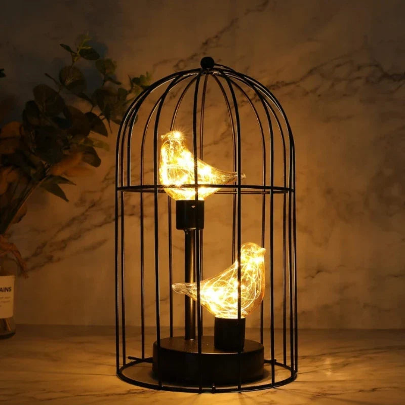 Decorative birdcage table lamp with warm LED glow, perfect for accent lighting & romantic home decor. USB/battery.