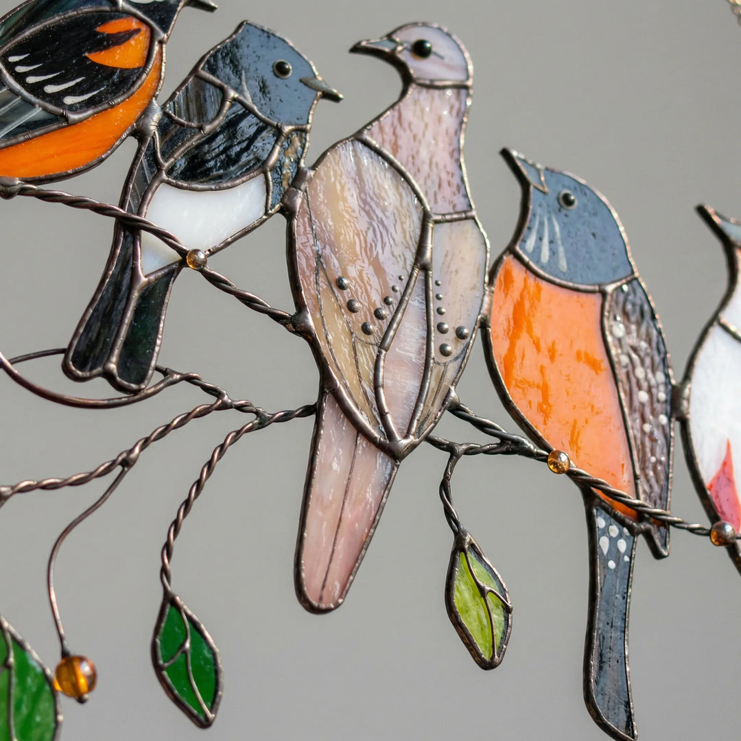Artistic colorful stained glass bird suncatcher, catching light in a window. Beautiful home accent and unique garden decor.