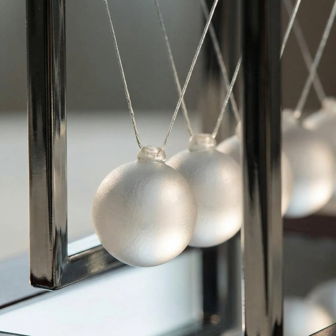 Unique kinetic desk gadget featuring a dynamic LED light show, a calming home accent for modern spaces.