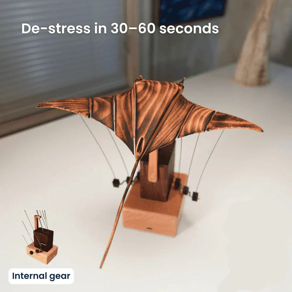 Hand-cranked kinetic wood manta ray desk sculpture, perfect ocean-themed desktop art for home office decor.