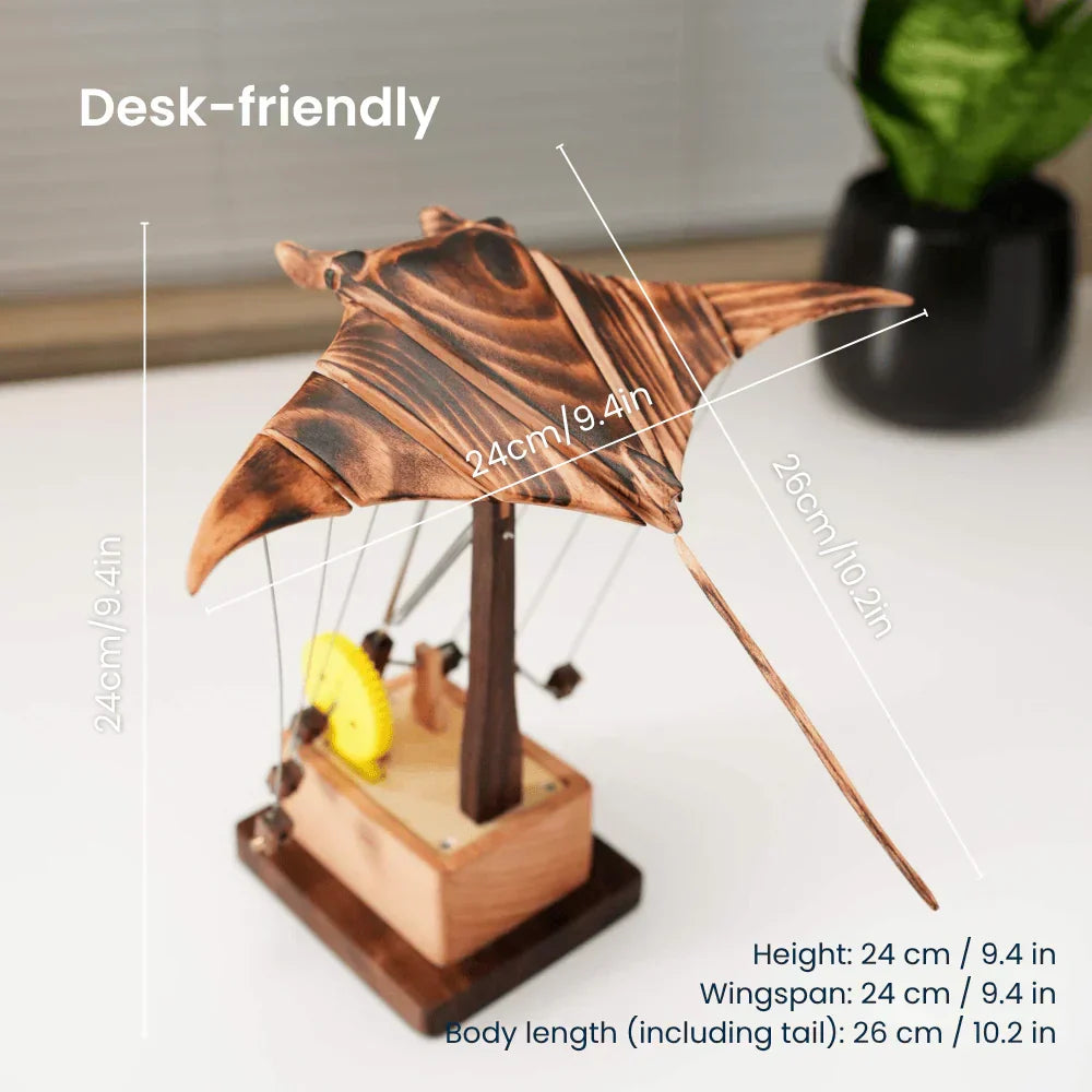 Unique ocean-themed gift: a hand-cranked kinetic wood manta ray desk sculpture, elegant mechanical art for display.