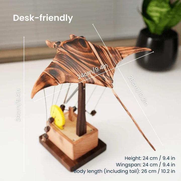 Unique ocean-themed gift: a hand-cranked kinetic wood manta ray desk sculpture, elegant mechanical art for display.