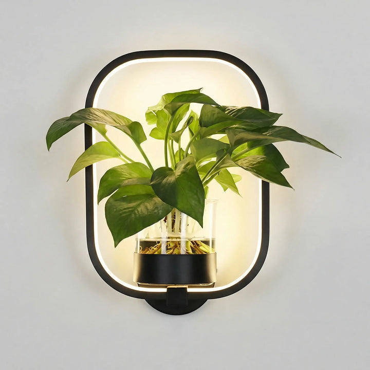 Chic modern wall sconce & plant holder, casting a gentle glow, perfect for compact indoor lighting and decor.