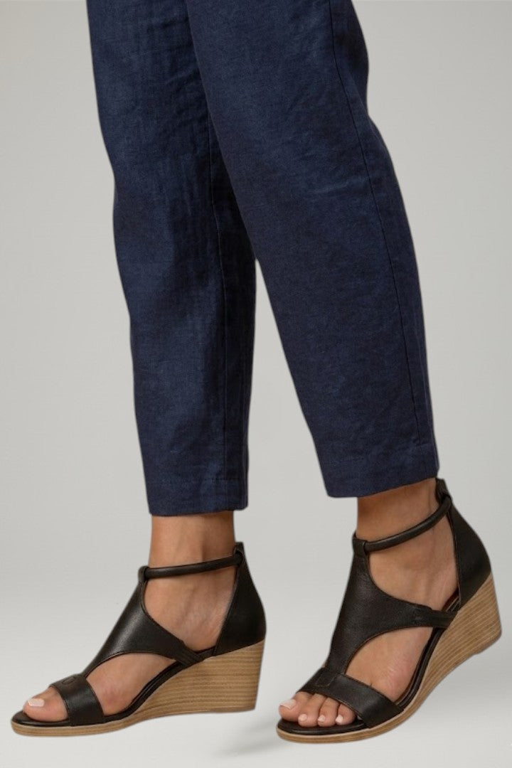 Fashionable women's T-strap wedge sandals with a supportive cushioned footbed for casual elegance.