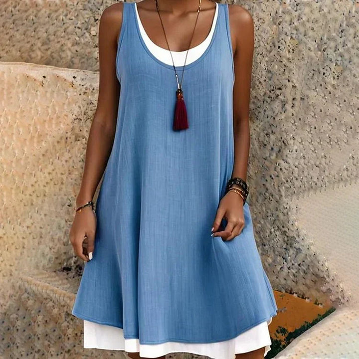 Versatile women's layered mini swing dress in black, featuring a sleeveless design and scoop neck for summer.
