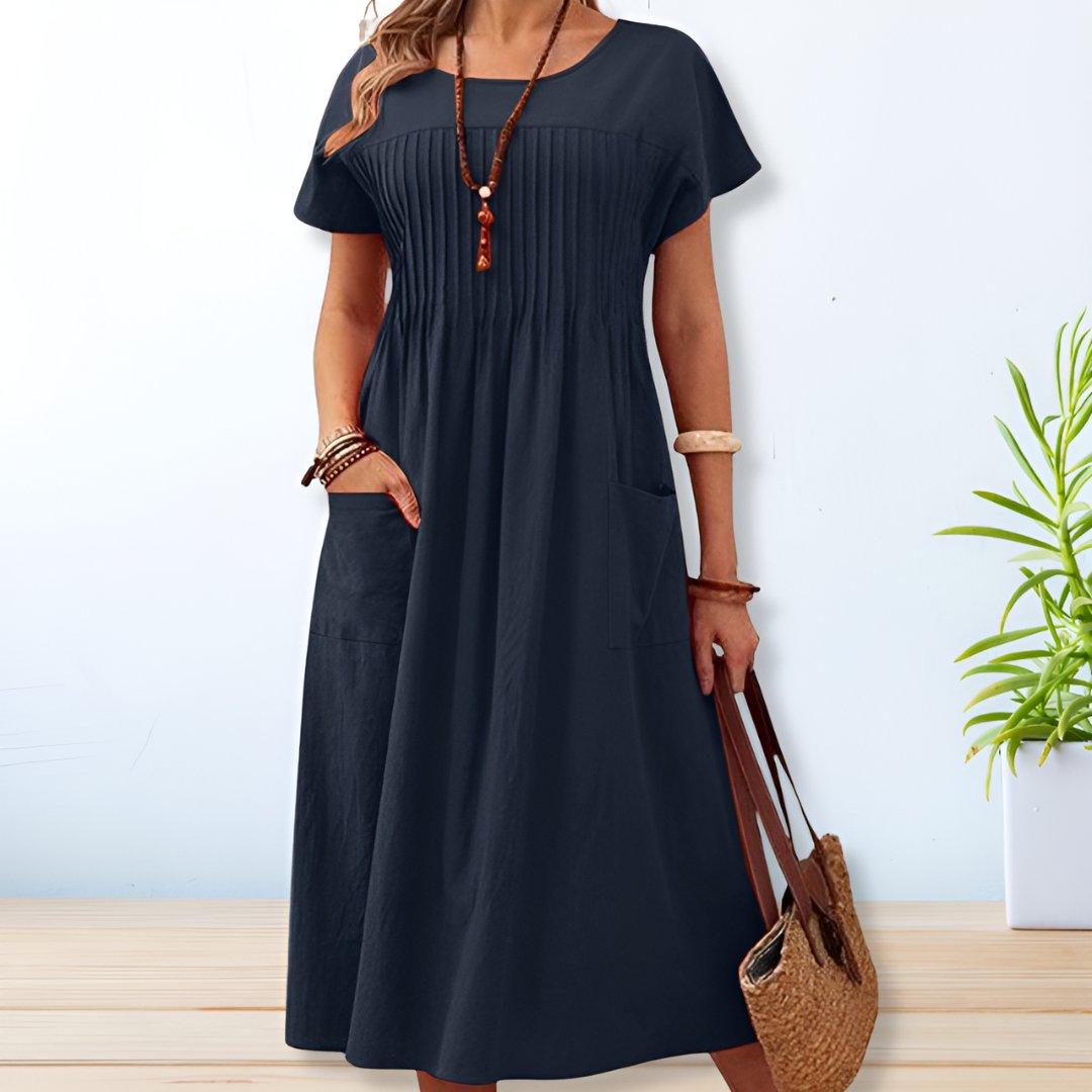 Stylish women's short sleeve midi day dress featuring a relaxed fit. Great for a comfortable, effortless casual summer look.