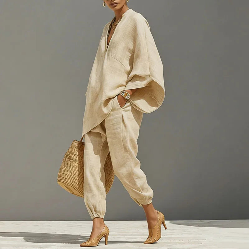 Woman wearing a relaxed apricot linen matching set, a comfortable two-piece outfit with batwing top & tapered pants.