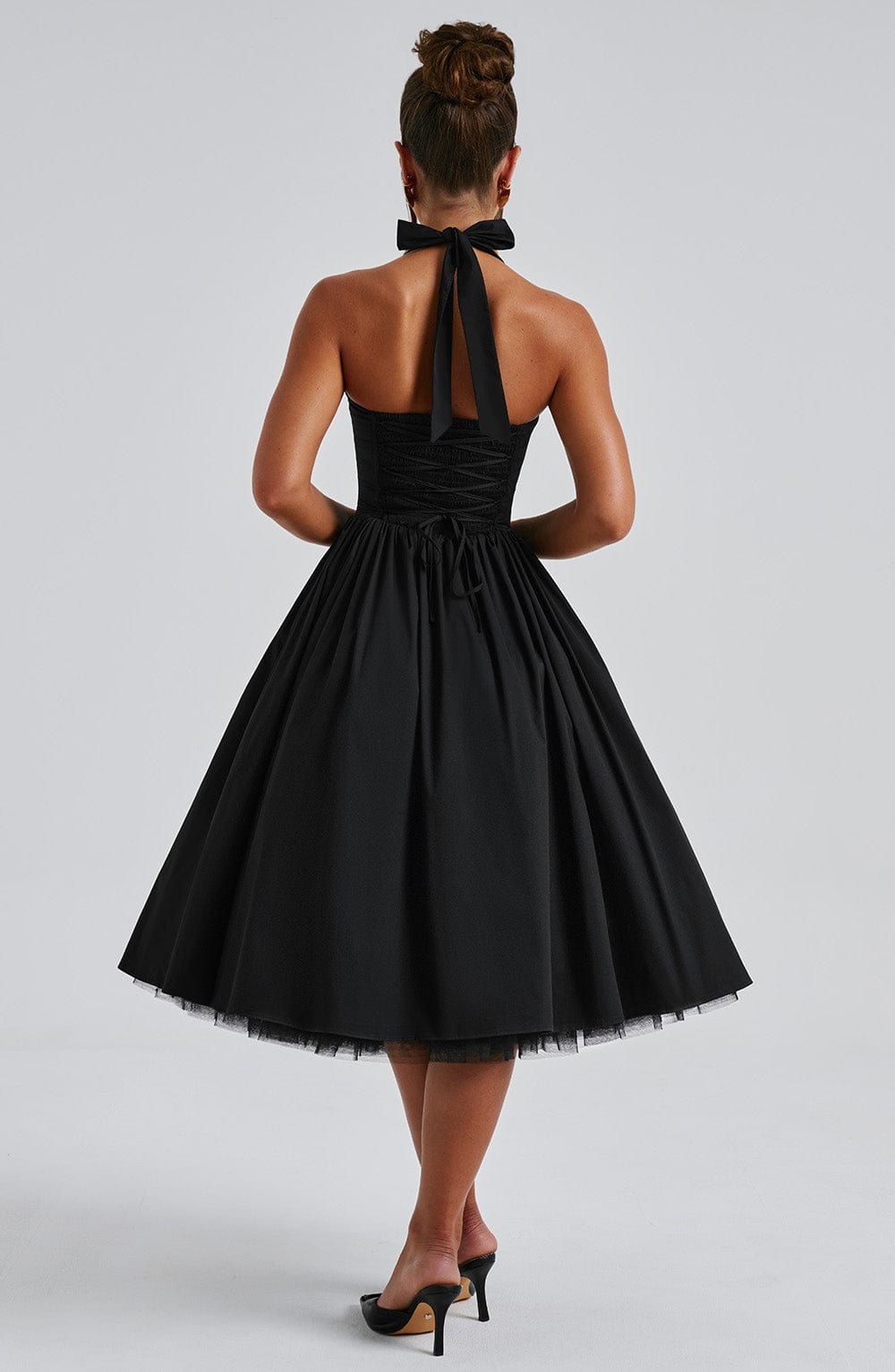 Stylish black and white halter midi dress, women's wedding guest outfit with classic midi length