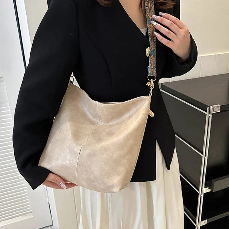 Chic women's bohemian shoulder bag with unique patterned strap. Faux leather hobo style, perfect for everyday carry.