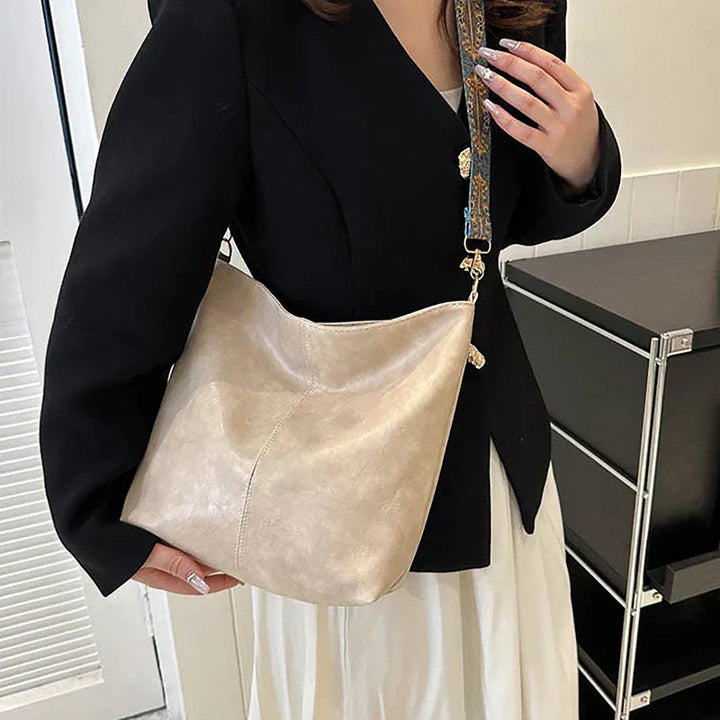 Chic women's bohemian shoulder bag with unique patterned strap. Faux leather hobo style, perfect for everyday carry.