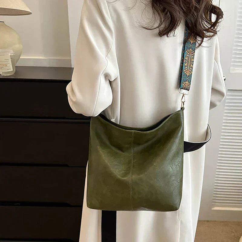 Faux leather boho hobo shoulder bag for women, featuring a stylish patterned strap. Trendy accessory.
