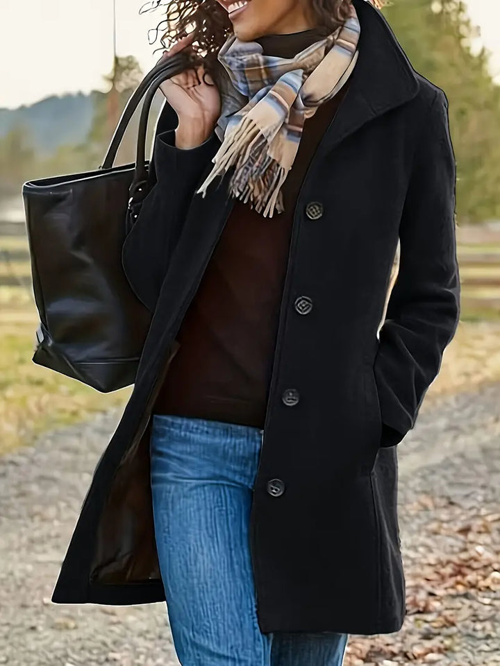 Fashionable women's button-front trench coat with a chic lapel. Tailored mid-length design for elegant fall/winter wear.