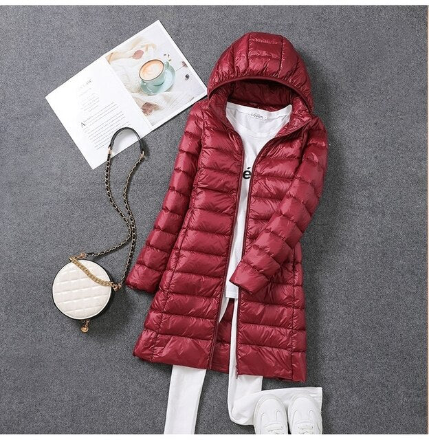 Women's long hooded puffer jacket, offering ultimate winter warmth & cozy style for cold weather.
