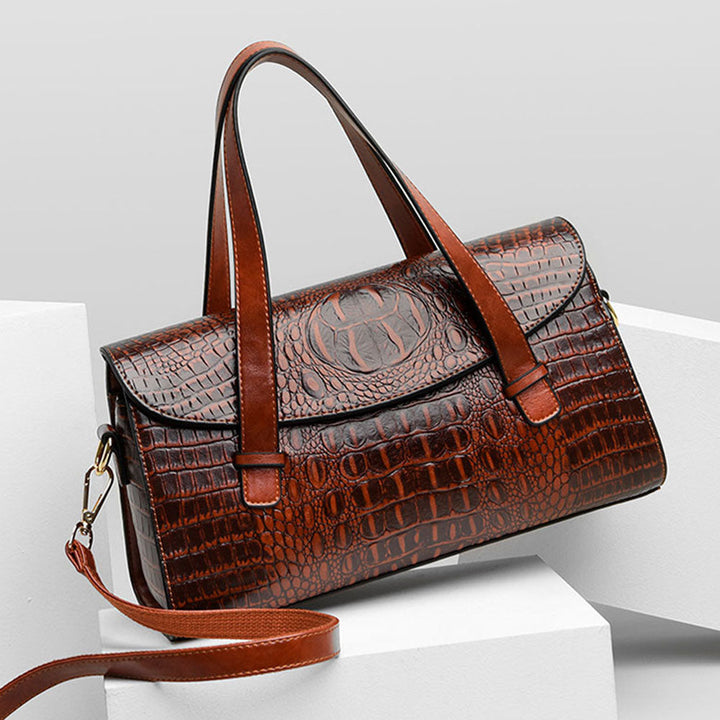 Elegant women's brown shoulder bag with luxurious crocodile embossing. Stylish and versatile fashion accessory.