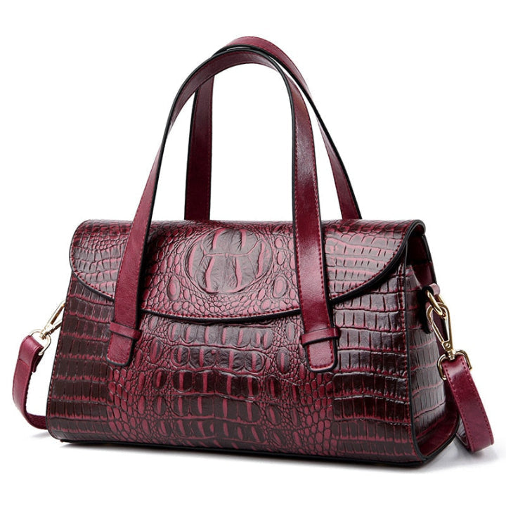 Close-up of elegant women's crocodile embossed shoulder bag, showcasing luxurious texture and design. Fashionable.