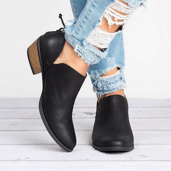 Comfortable women's ankle boots featuring a stylish low block heel, back zip, and rounded toe for everyday wear.