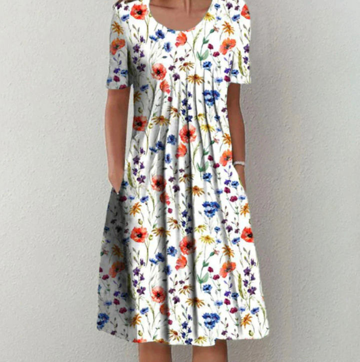 Chic women's printed A-line summer midi dress with elegant pleats, perfect for casual or vacation wear.