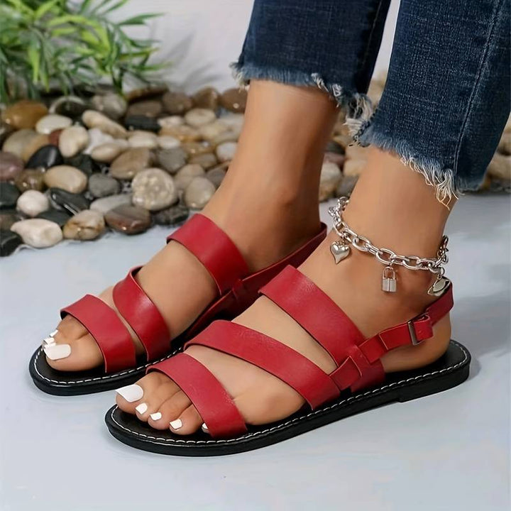 Comfortable women's three-strap flat sandals. Stylish open-toe design, ideal chic footwear for summer & warm weather.