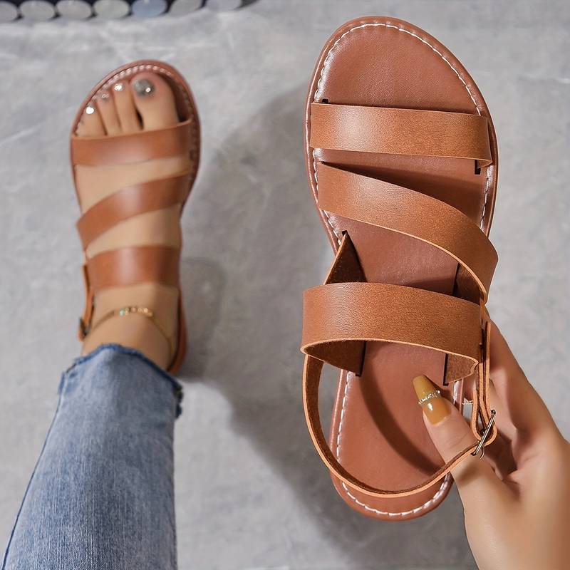 Women's summer flat sandals featuring a chic three-strap design. Comfortable open-toe footwear for warm weather casual outfits.