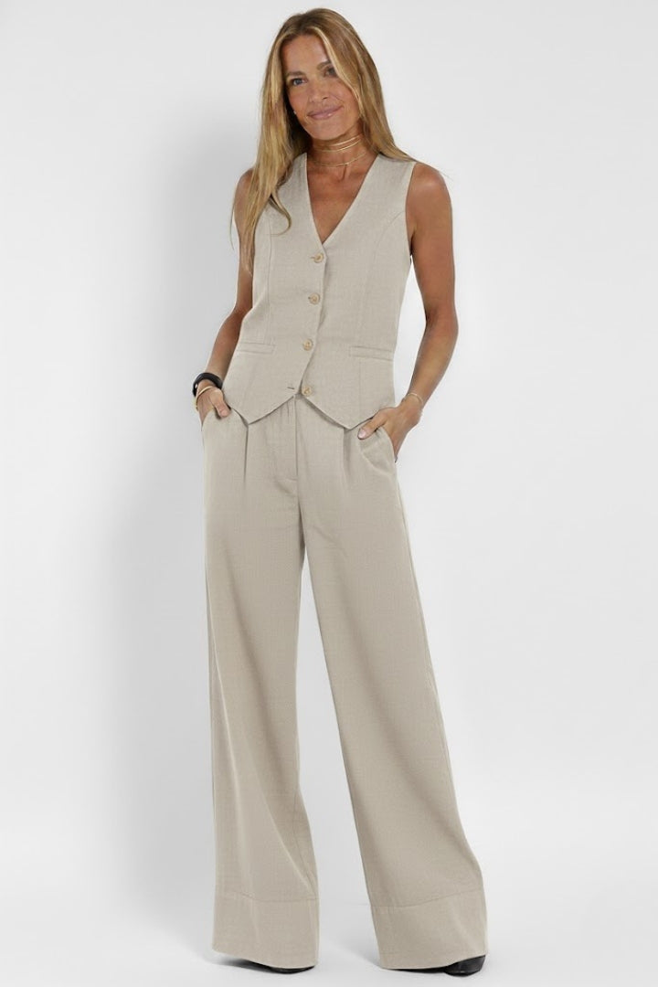 Coordinated women's V-neck vest and wide-leg trousers set. Perfect chic summer fashion outfit.