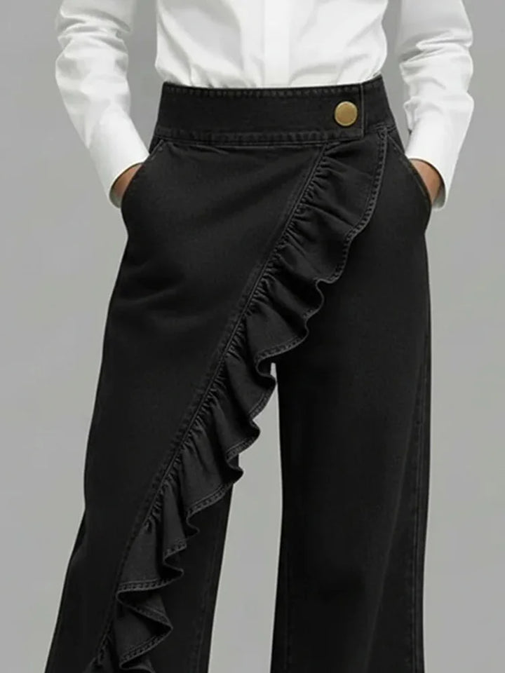 Stylish women's wide leg denim jeans with high-rise waist and elegant ruffle detail. Flowing & comfortable.
