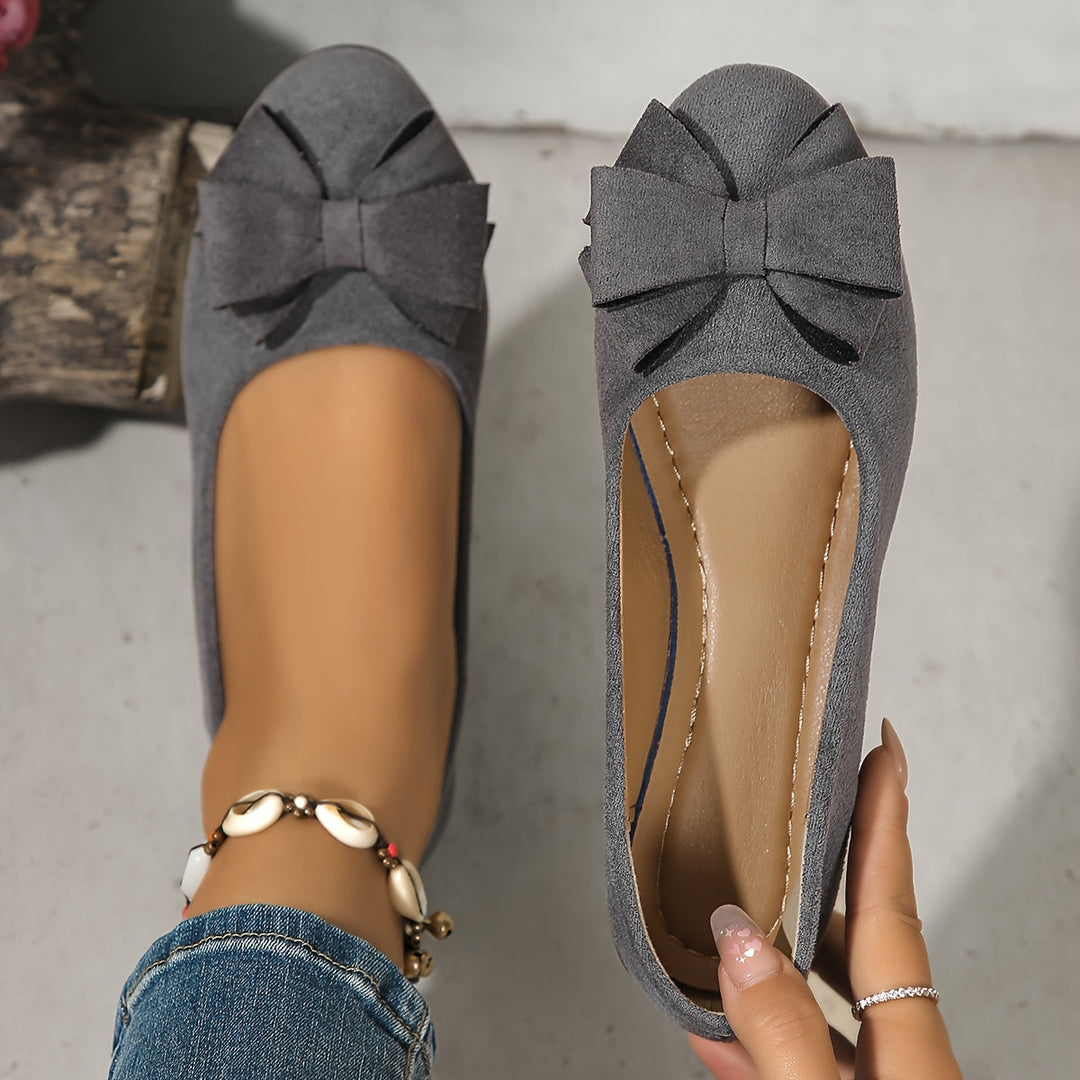 Women's comfortable slip-on wedges, featuring a stylish bow, perfect for casual elegance.