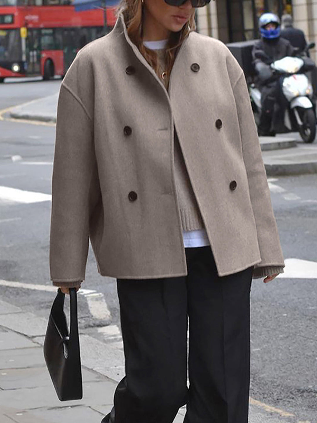 Full-length view of a women's double-breasted trench coat, showcasing its classic workwear style