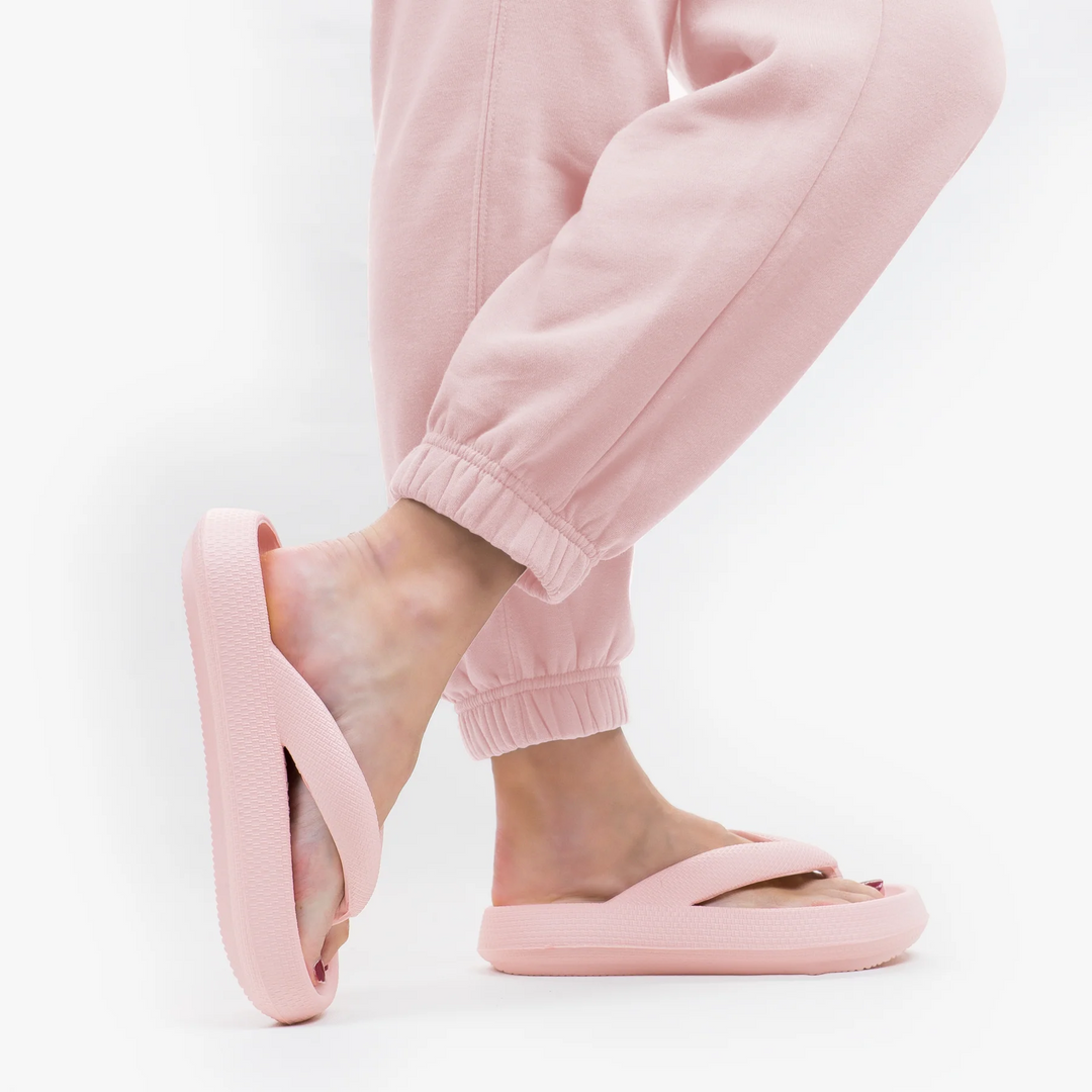 Cushioned comfort slides, perfect for travel essentials or as soft house slippers. Unisex design.