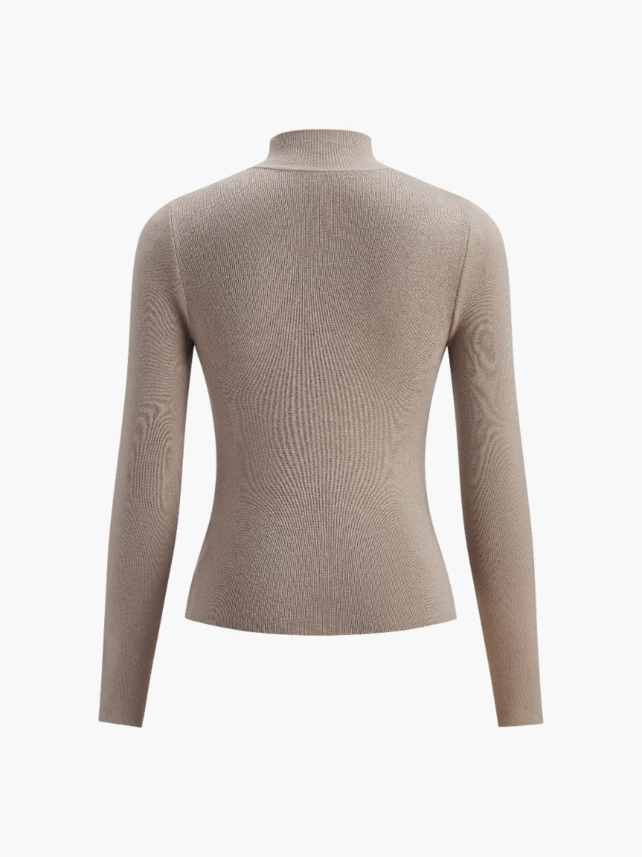 Back view of an elegant women's mock neck long sleeve top, emphasizing its smooth design