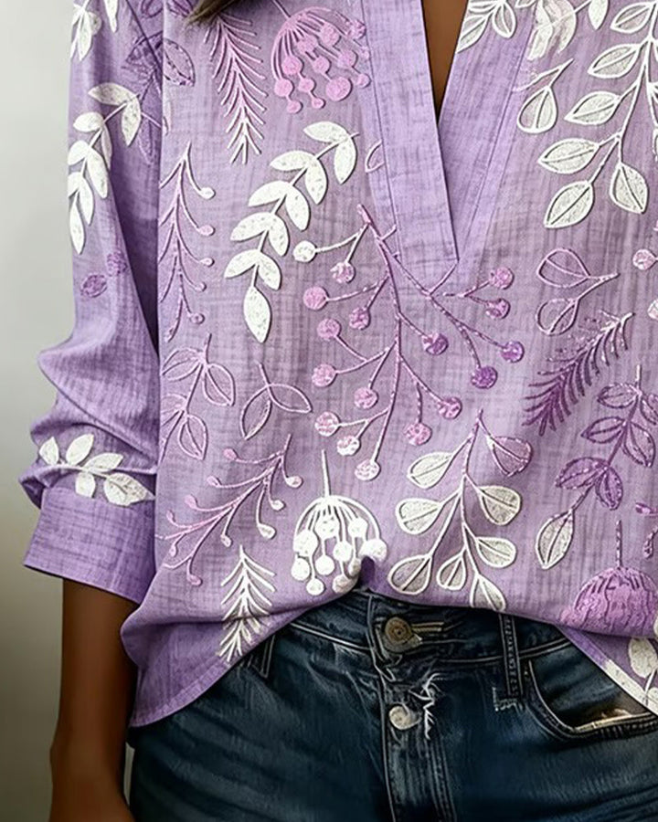 Elegant Women's V-Neck Blouse with a soft pastel floral print, versatile for office or casual.