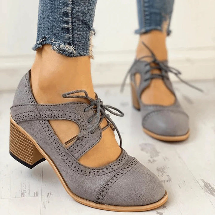 Pair of women's comfortable heeled lace-up T-strap dress shoes in beige, ideal for all-day wear
