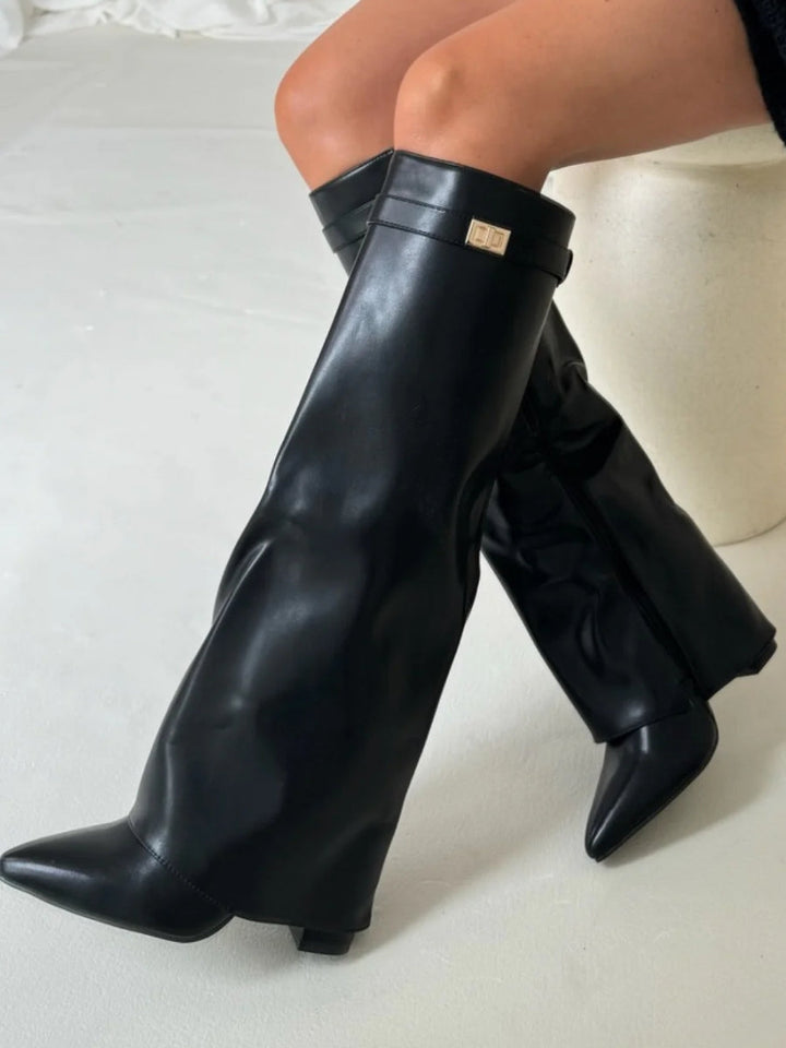 Luxury leather thigh-high boots for women, enhanced with fashionable buckle elements.