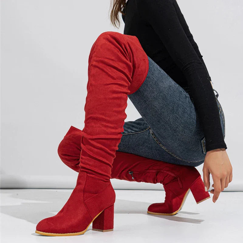 Stylish heeled over-the-knee boots in black, offering a chic and elegant footwear option.
