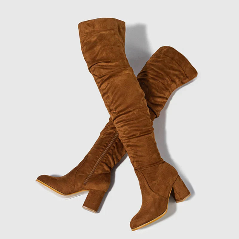 Textured shot of the elegant over-the-knee boots, emphasizing material and refined details.
