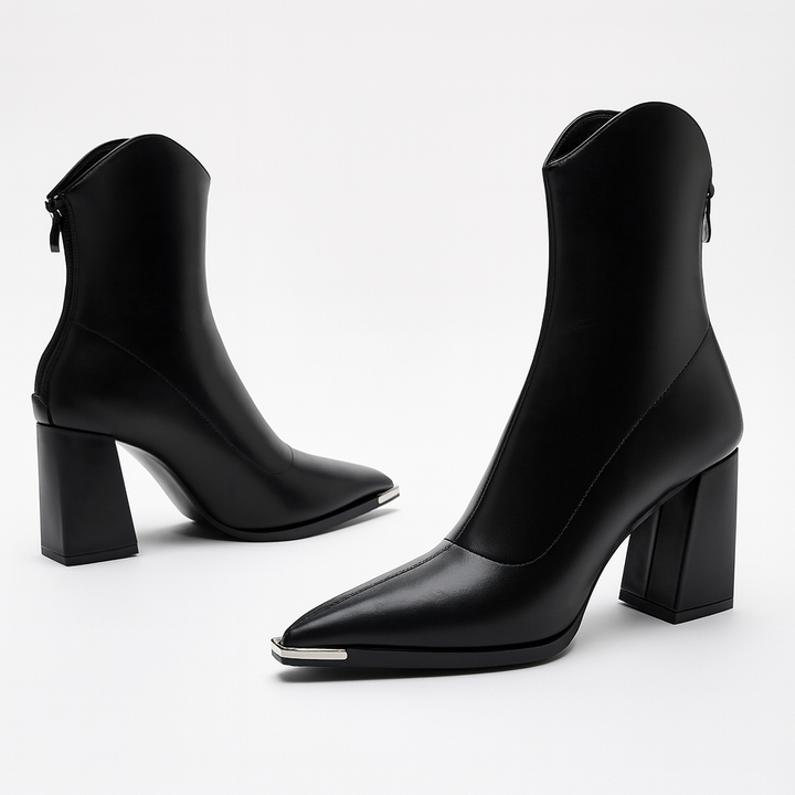 Pair of black pointed toe ankle boots with a comfortable heel, ideal for spring casual chic outfits.