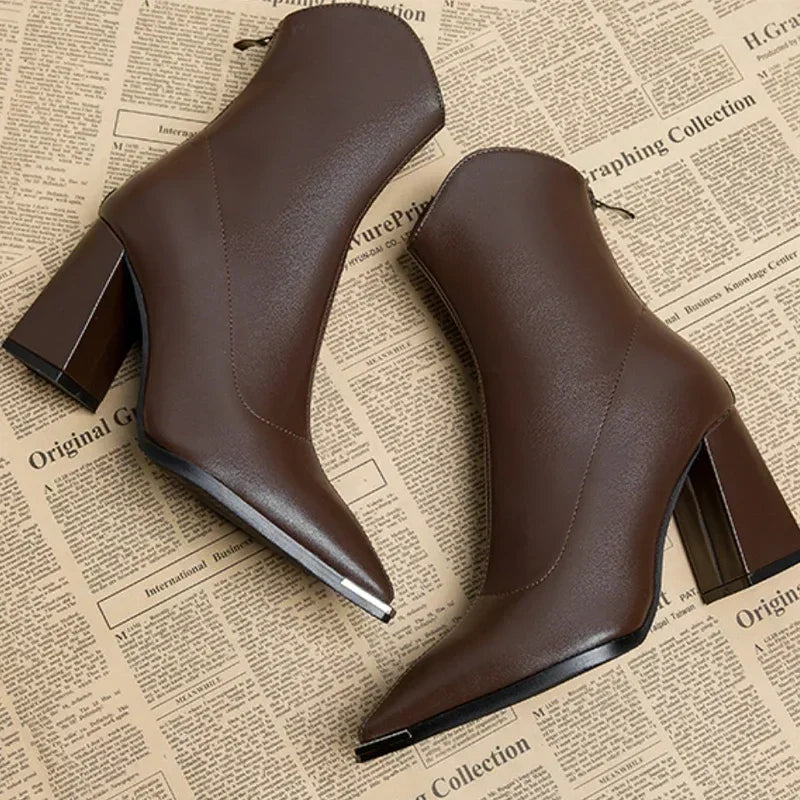 Women's pointed heel ankle boots styled with casual spring attire, showing their versatile appeal.