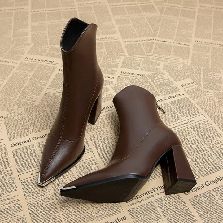 Close-up of the heel on women's pointed toe ankle boots, demonstrating stability and fashionable design.