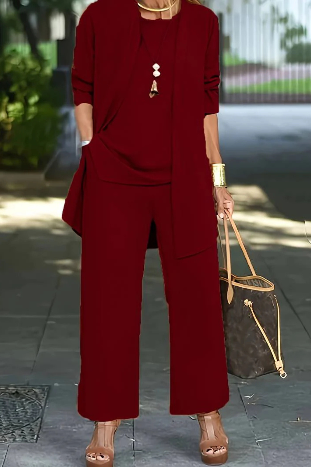 Side profile of a woman in a classy red formal 3-piece set, suitable for special occasions.