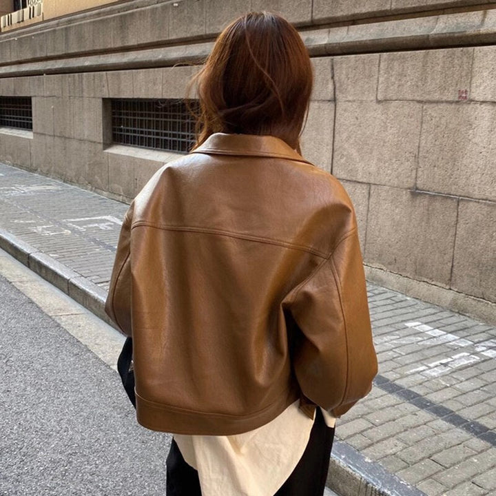Stylish women's zip-up jacket in brown, featuring a cropped design for a casual chic look
