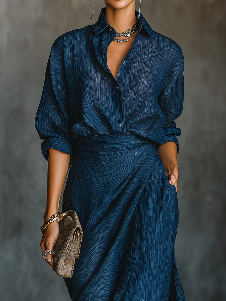 Stylish dark blue women's two-piece set with a v-neck wrap top & high-waist maxi skirt for a chic, versatile look.