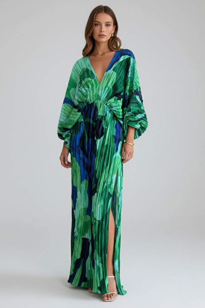 Women's flowing V-neck long dress in a vibrant green with a beautiful pleated skirt and printed pattern.