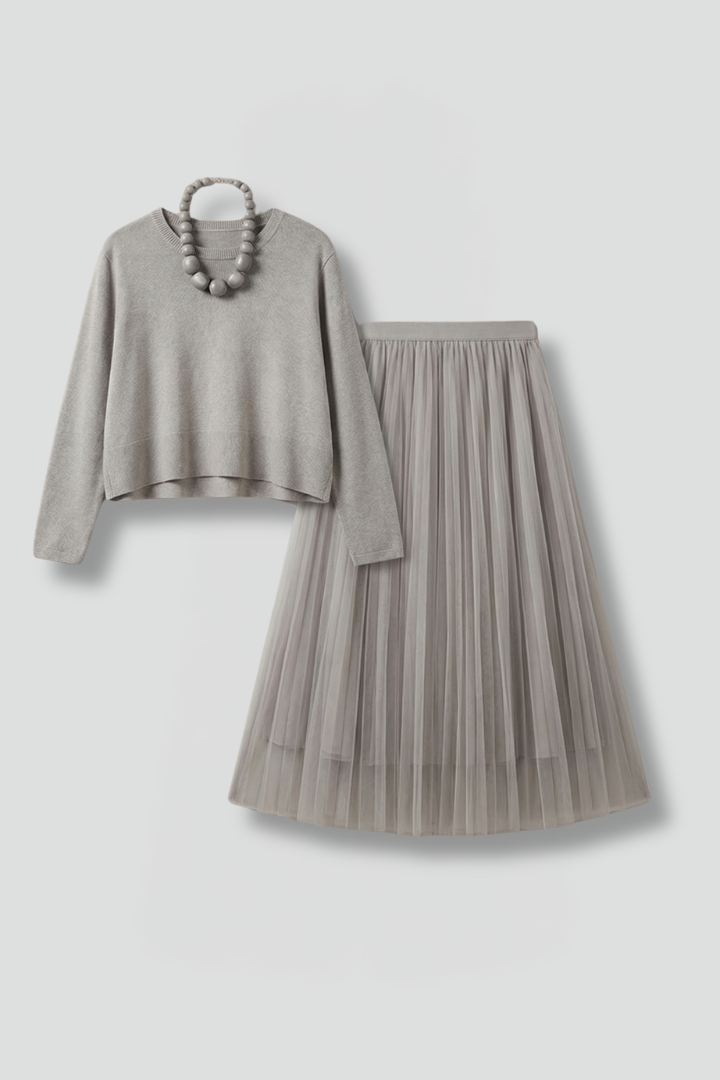 Elegant layered midi dress for women, featuring a pleated skirt and long sleeves. Perfect autumn fashion.