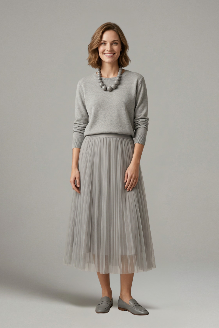 Women's layered midi dress with a flowing pleated skirt, round neck, and elegant long sleeves. Versatile fashion.