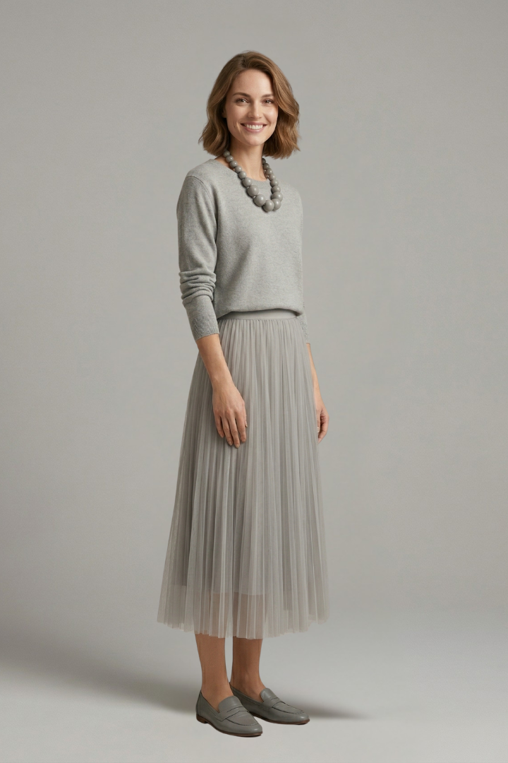 Chic women's long-sleeve midi dress, showcasing a stylish layered design and elegant pleated skirt. Casual or formal.