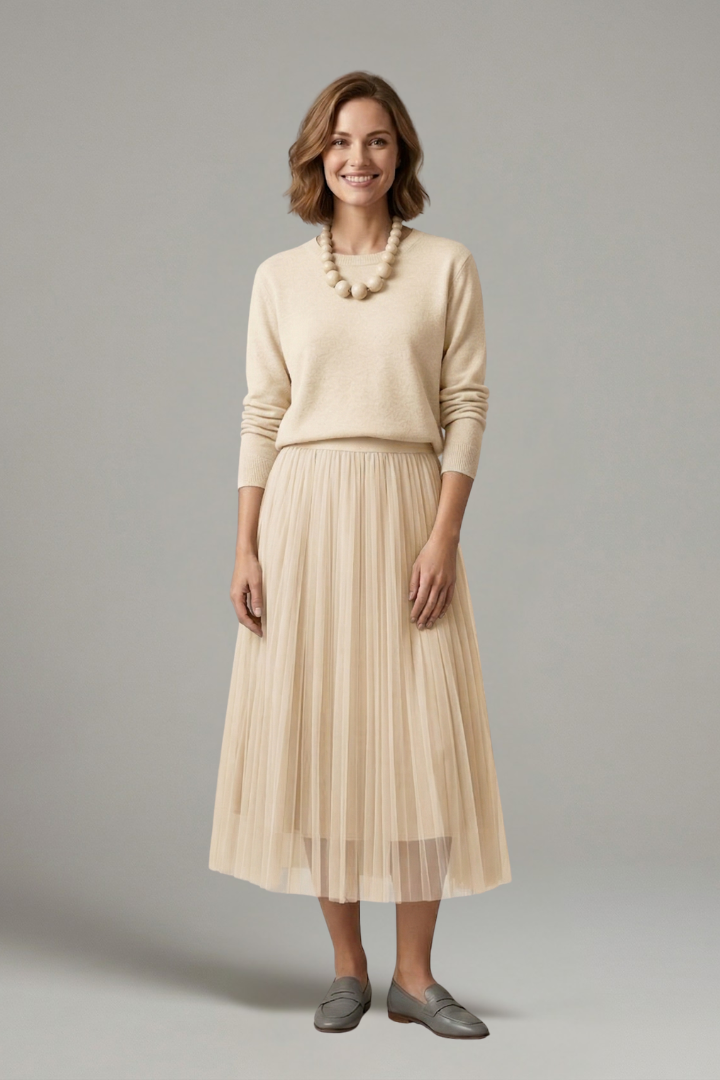 Stylish women's layered midi dress featuring an elegant pleated skirt and long sleeves. Ideal for autumn fashion.