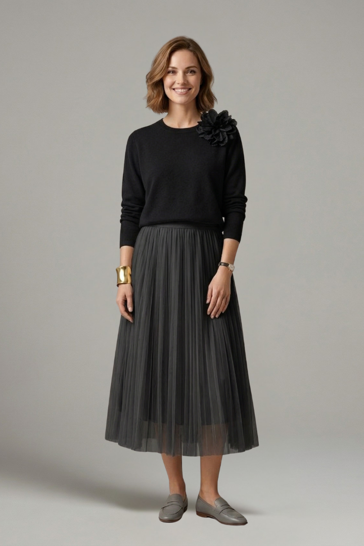 Sophisticated women's layered midi dress with a graceful pleated skirt. Elegant fashion for formal events.