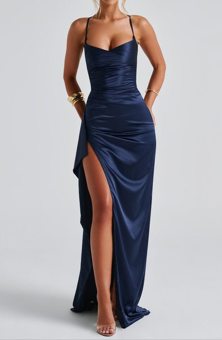 Beautiful women's navy blue maxi dress with a daring high slit and delicate straps, fashionable resort wear.