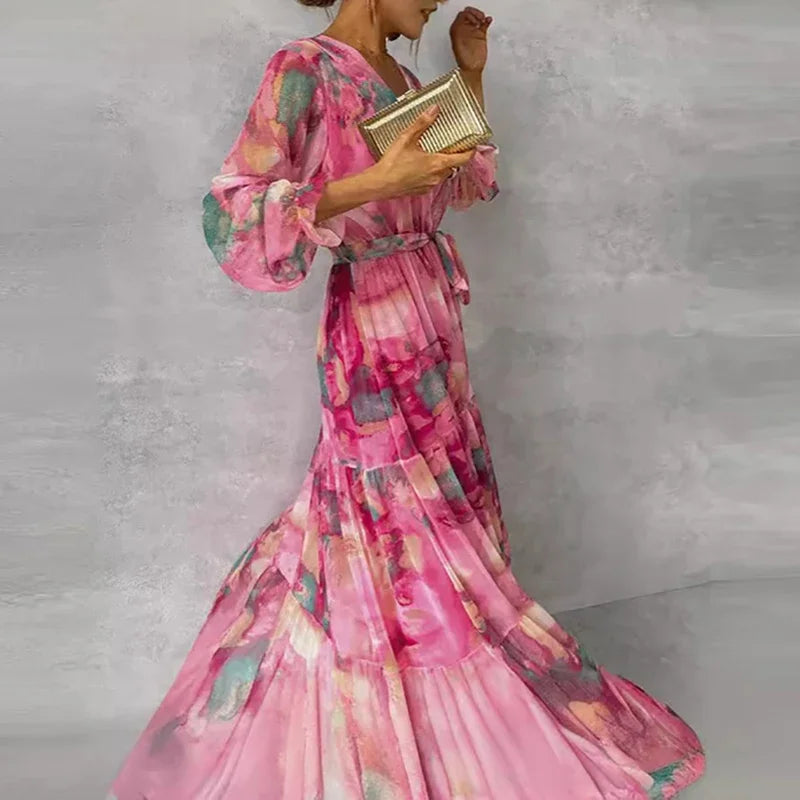 Beautiful women's floral wrap maxi dress in pink, with a chic V-neck, long sleeves, and flowy tiered design.