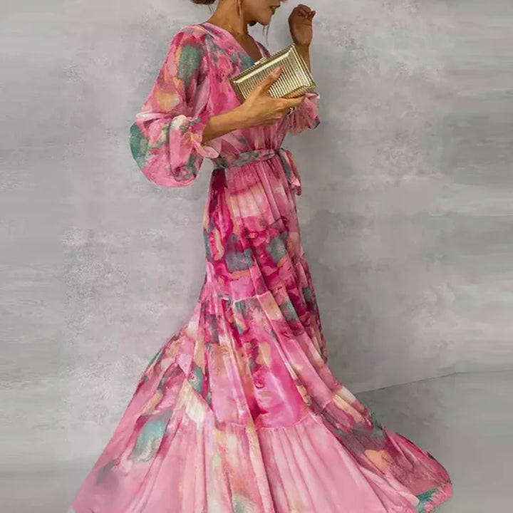 Beautiful women's floral wrap maxi dress in pink, with a chic V-neck, long sleeves, and flowy tiered design.